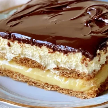 No-bake eclair cake topped with chocolate and whipped cream