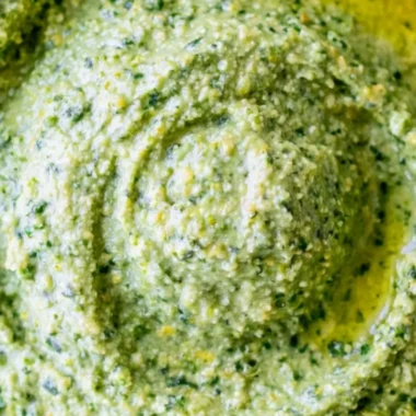 Bowl of nut-free pesto sauce with fresh basil and garlic
