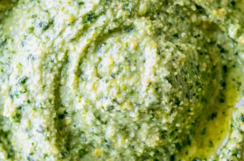 Bowl of nut-free pesto sauce with fresh basil and garlic