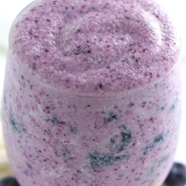 Healthy blueberry banana smoothie with protein ingredients in a glass