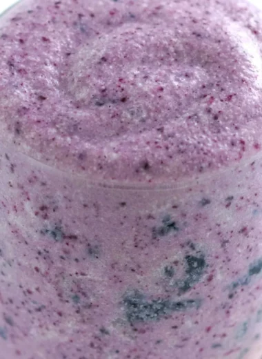 Healthy blueberry banana smoothie with protein ingredients in a glass