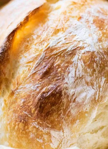 Homemade no-fail sourdough bread loaves on a wooden table