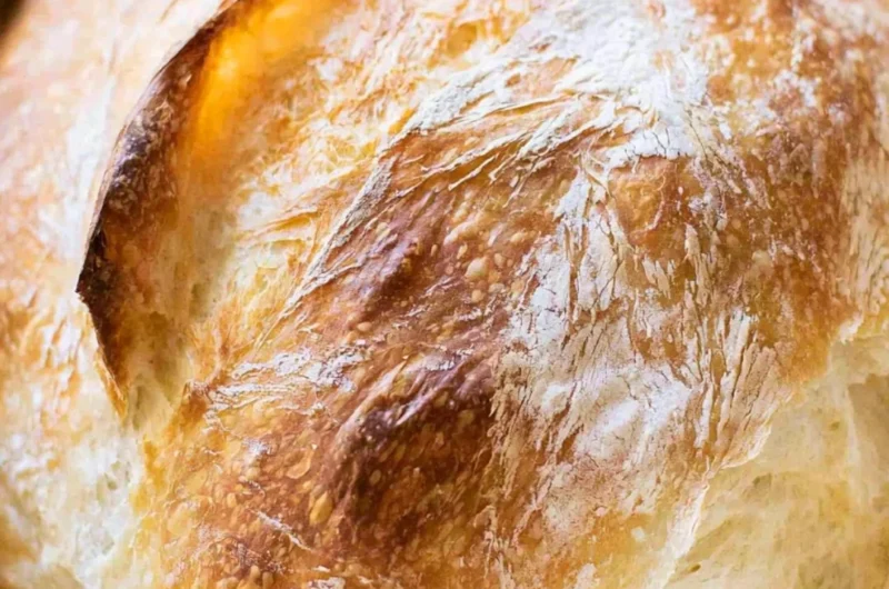 Homemade no-fail sourdough bread loaves on a wooden table