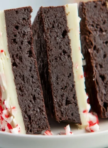 Cozy peppermint bark brownies topped with crushed candy canes and chocolate drizzle.