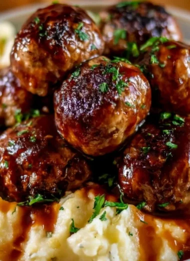 Cozy Salisbury steak meatballs on a plate with garlic herb mashed potatoes
