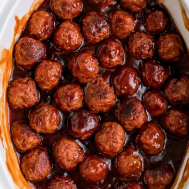 Three-ingredient grape jelly meatballs served on a platter